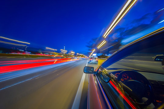 View from Side of Car moving in a night city