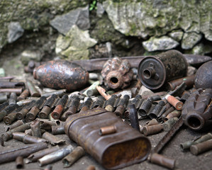 Military background with cartridges of grenades and machine-gun tape. Black archeology. World War II and its artifacts. Great Patriotic War of the USSR