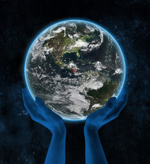 Nicaragua on night planet Earth in hands