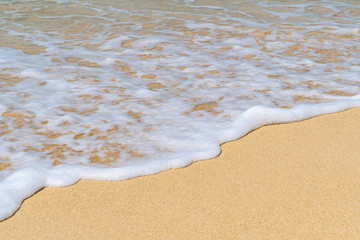Rich sea foam on white sand beach. Seashore. Space to add text.