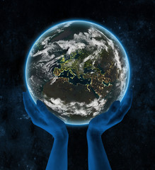 Kosovo on night planet Earth in hands