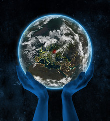 Belarus on night planet Earth in hands