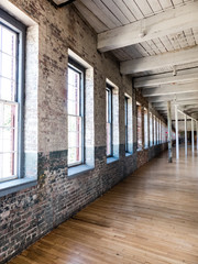 brick wall and wood floor in renovated abandoned mill building