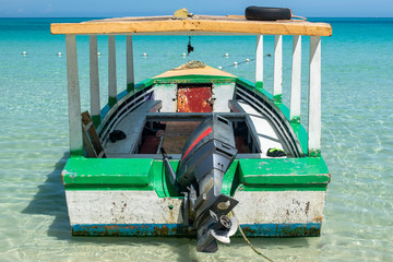 Motor boat used for tours and for fishing, moored along the Seven Mile Beach in Negril, Jamaica
