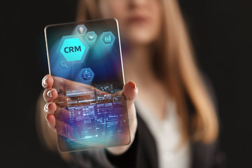 The concept of business, technology, the Internet and the network. A young entrepreneur working on a virtual screen of the future and sees the inscription: CRM