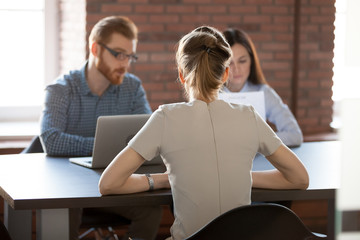Female job candidate recruitment process in office, hr team reading applicant resume, recruiters...