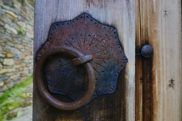 Old rusty opened lock without key. Vintage wooden door, close up concept photo. Security, metal.