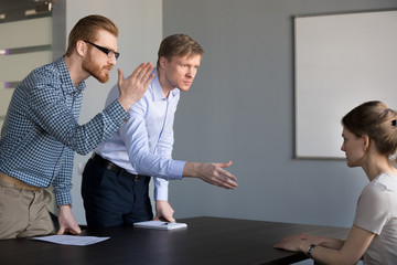 Mad businessmen irritated by improper behavior of applicant during job hiring, furious male hr managers yelling at employee. Bad interview, conflict office situation, gender discrimination concept