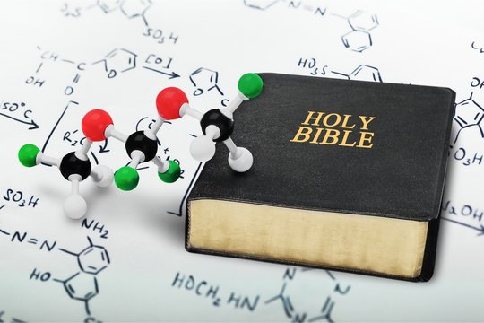 Holy bible and chemistry form, close-up view