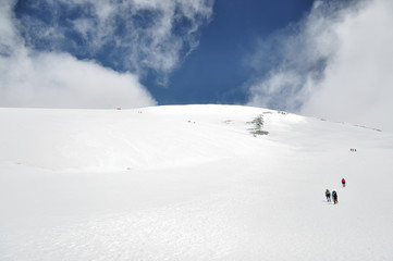 Mountaineers on their way over a glacier to the Breithorn summit near Zermatt