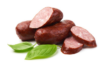 Bratwurst smoked pork sausages with sausage slices and green fresh basil leaves, isolated on white background.