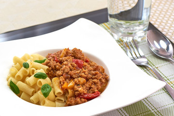 American food. Pasta alla genovese. Pasta with corn, fried meat and sauce.