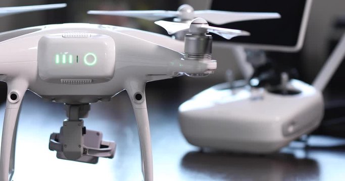 Pilot Turns On Drone Quadcopter With Controller Behind