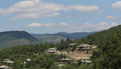 Stone house with stone fence in the Village of Leshten. Historical, facade. The Village of Leshten is architectural reservation