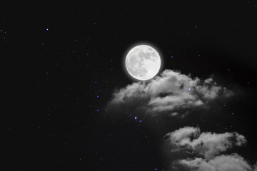 Romantic night. Full moon  over cloudscape with wood background.