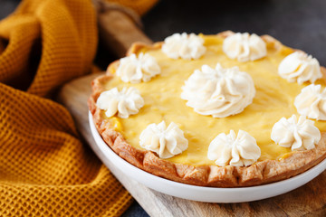 Traditional shortcrust pastry lemon tart with citrus custard and whipped cream