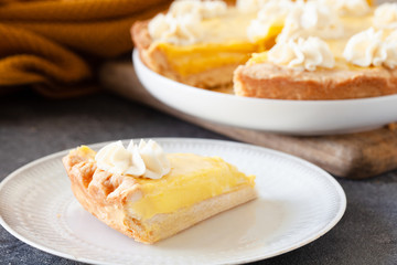 Traditional shortcrust pastry lemon tart with citrus custard and whipped cream