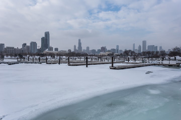 Several empty boat docks in front of Chicago skyline