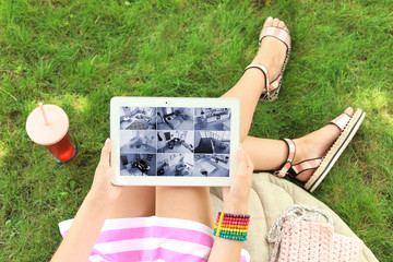Woman holding tablet with blank screen outdoors. Mockup for design