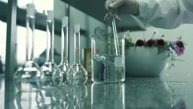 The pharmacist mixes the chemical extract