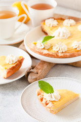 Traditional shortcrust pastry lemon tart with citrus custard and whipped cream