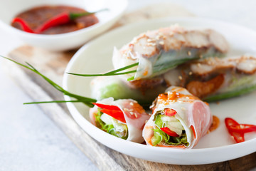 Fresh spicy vietnamese salad rolls with shrimp on a white plate