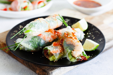 Fresh spicy vietnamese salad rolls with shrimp on a white plate