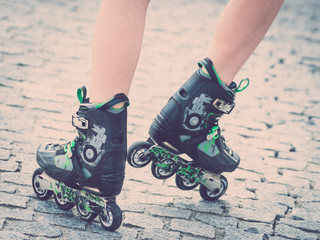 Fototapeta na wymiar Woman legs wearing roller skates