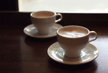 Cups of fresh aromatic coffee on table