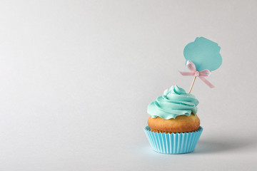 Delicious birthday cupcake and space for text on gray background