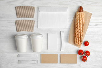 Flat lay composition with items for mock up design on wooden background. Food delivery service