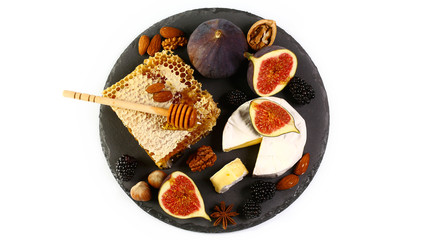 Camembert cheese with honey, figs, walnuts on stone board isolated on a white background, Flat lay, Copy space