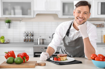 Professional chef in uniform at restaurant kitchen