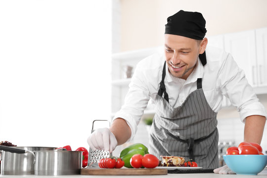 Professional chef in uniform working at restaurant kitchen