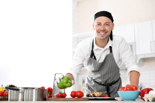 Professional chef in uniform working at restaurant kitchen
