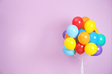 Bunch of bright balloons and space for text against color background © New Africa