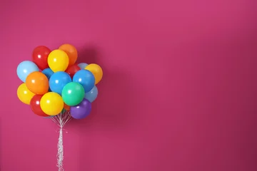 Gardinen Bunch of bright balloons and space for text against color background © New Africa