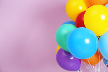 Bunch of bright balloons and space for text against color background