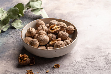 Walnuts in ceramic bowl. 