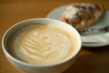 Coffee latte, cappuccino with a croissant
