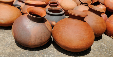 Background of a pots, dishes, and other articles made of baked clay. Wide photo.