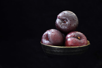 Fresh fruit in metal bowl with black background 