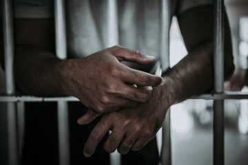 Hands of men desperate to catch the iron prison,prisoner concept,thailand people,Hope to be free.