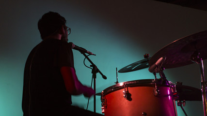 A drummer on a stage at night 