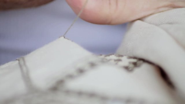 Senior woman doing traditional stitch patterns on Lefkara lace