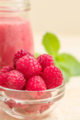 Raspberry smoothie close up photography with fresh summer blended cocktail and ripe berries.