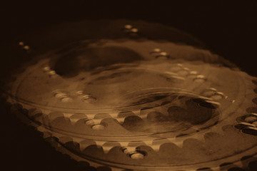 Monochrome multi exposition background of gear close up. Artwork from auto part in macro photography. Sepia tones.