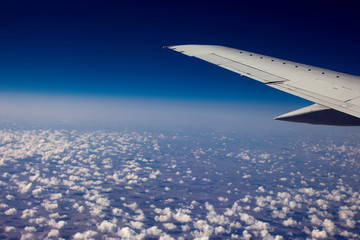 Obraz premium Beautiful view of cumulus clouds with sunrise at atmosfera from airplain window