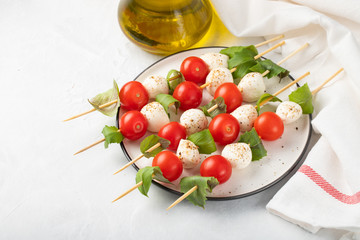 Caprese salad - skewer with tomato, mozzarella and basil, italian food and healthy vegetarian diet...