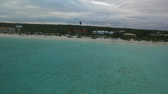 Person parasails in Turks and Caicos, aerial